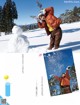 A woman standing in the snow with a snowman in the background.