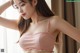 A woman wearing a pink bra and panties posing for a picture.