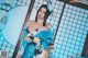 A woman in a blue and white kimono posing for a picture.